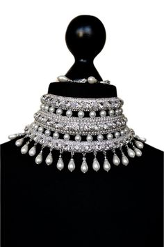 Bridal embroidered necklace in silver tones with white pearls and crystal beads for bride. This necklace can decorate any neck. It can be dressed for a wedding, engagement or for a holiday or New Year's party There are 3  clasps at the back for a secure fit. The length of the chocker is adjustable.  Only high-quality materials were used in the creation of this gorgeous necklace Earrings I put as a gift) length - 31.5 cm (12.2 inch) width - 9 cm (3.4 inch) weight - 135 gram In this necklace you will be absolutely incomparable and unique. You will get a lot of compliments and enthusiastic looks from others  Buying a necklace a pleasant gift awaits you You might also like https://www.etsy.com/shop/AliceCrownStore?ref=seller-platform-mcnav&section_id=35435354 If you have any questions please c Glamorous White Pearl Necklace, Elegant White Choker For Reception, Silver Pearl Necklace With Rhinestones For Wedding, White Rhinestone Choker For Wedding, Embellished White Jewelry For Festive Occasions, Festive White Embellished Jewelry, Silver Pearl Necklace With Stone Work For Wedding, Silver Choker For Reception, Silver Crystal Bridal Necklace With Stone Work