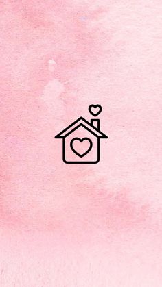 a pink wall with a black birdhouse on it's side and a heart at the top