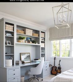 a bedroom with a bed, desk and shelves in it's center area next to a window