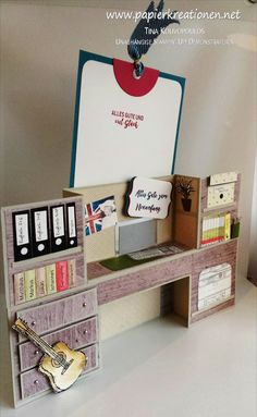 a desk with a guitar and some books on it