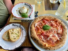 two plates with food on them sitting on a table