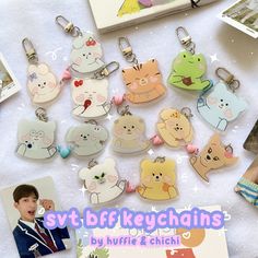 a bunch of keychains that are on a table with some pictures and other items