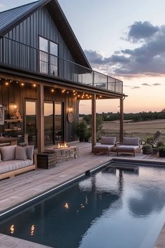 a house with a pool in the middle of it and patio furniture on the other side