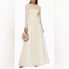 Belted, Long Sleeve, Embroidered Dress With Pleating. Beautiful White And Off White Detailing. Elegant Floral Embroidered Maxi Dress For Wedding, Elegant Spring Embroidered Wedding Dress, Elegant Silk Maxi Dress With Floral Embroidery, Elegant Long Sleeve Evening Dress With Floral Embroidery, Elegant Floral Embroidered Maxi Dress For Evening, White Floor-length Dress With Floral Embroidery, White Floral Embroidery Floor-length Dress, Elegant Cream Dress For Banquet, Elegant Embroidered Wedding Dress