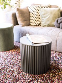 a living room area with a couch, coffee table and colorful rugs on the floor