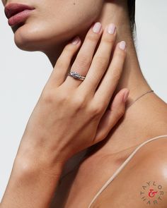 a woman's arm with a tattoo on it and a ring in her hand