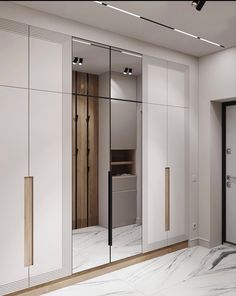 an empty room with mirrored doors and marble flooring on the walls, in front of a closet