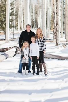 a family posing for a photo in the snow