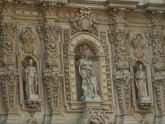 statues on the side of an old building