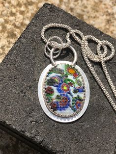 This stunning cabachon is from the 1920's it's made using traditional millefiori glass that is then pressed into a mould before cooling. This gives the snakeskin appearance. A small amount of uranium is also added before cooling Artisan Multicolor Cabochon Necklace, Glass Cabochon Pendant Jewelry, Multicolor Cabochon Necklaces, Glass Pendant Necklace With Cabochon, Traditional Oval Cabochon Necklace, Traditional Oval Cabochon Necklaces, Multicolor Cabochon Round Pendant Necklace, Handmade Multicolor Oval Cabochon Jewelry, Handmade Multicolor Jewelry With Oval Cabochon