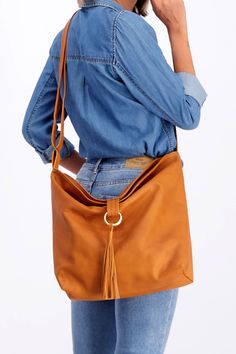 Our MAYKO Hobo crossbody bag is handmade from the finest soft Italian leather, and it will be a fabulous addition to your bag collection. Secured by a metal ring closure, the bag has a spacious compartment for all of your belongings. It featured an inside pocket for your mobile, and an adjustable crossbody strap to ease the weight on your shoulder.  #Travel #TravelBag #SchoolBag #WorkBag #DesignerBag #LuxuryBag #LeatherBag #Luxury #Design #Designer #Women'sFashion #Women'sStyle #StreetStyle #DIY Everyday Crossbody Hobo Bag With Leather Handles, Daily Leather Handle Crossbody Shoulder Bag, Daily Leather Handles Crossbody Shoulder Bag, Everyday Leather Handle Crossbody Saddle Bag, Daily Crossbody Satchel, Everyday Leather Crossbody Hobo Bag, Daily Soft Leather Crossbody Satchel, Soft Leather Crossbody Bucket Bag, Daily Crossbody Hobo Bag With Removable Pouch