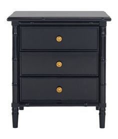 a black nightstand with three drawers and gold knobs on the bottom, against a white background