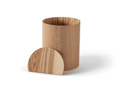 a wooden cup sitting on top of a white surface