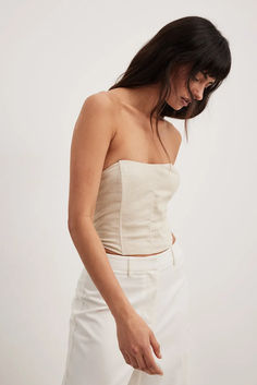 Linen Blend Corset Top Spring Beige Corset With Built-in Bra, Beige Corset With Built-in Bra For Spring, Beige Sleeveless Corset With Boned Bodice, Beige Boned Bodice Sleeveless Corset, Fitted Beige Top With Boned Bodice, Beige Sleeveless Top With Boned Bodice, Chic Cream Corset For Spring, Beige Strapless Corset With Corset Back, Strapless Beige Corset With Corset Back