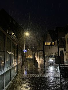 a city street at night in the rain