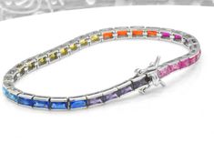 Here we have a beautiful and exquisite multi-color simulated sapphire tennis bracelet. All emerald cut gemstones are bezel set. There is an impressive 8 cts of weight of gemstones. The bracelet is 7-inches long and about 1/8-inch thick. This bracelet was designed to allure and impress with beautiful 14k white gold finish. It will be an excellent addition to a jewelry collection due to its uniqueness. Why spend thousands for the same look. The bracelet is made out of solid 925 Sterling Silver wit Sapphire Tennis Bracelet, Birthday Bracelet, Lock Style, Eternity Band Ring, Tennis Bracelet, Italian Charm Bracelet, Chain Link Bracelet, Eternity Ring, Bezel Setting