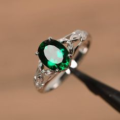 It is a lab emerald ring. The main stone is 7mm*9mm oval cut, weight about 1.58 carats. The basic metal is sterling silver and plated with rhodium. To change the metal to a solid gold (white/rose) or platinum is also available, please ask for a quotation if you want. You can also go to my shop Home for more elegant rings: https://www.etsy.com/shop/godjewelry?ref=hdr_shop_menu More emerald rings: https://www.etsy.com/shop/godjewelry?ref=seller-platform-mcnav&section_id=20709240 Customization Wedding Ring Oval, Smaragd Ring, May Birthstone Rings, Green Emerald Ring, Man Made Diamonds, Ring Oval, Elegant Ring, Diamond Solitaire Engagement Ring, Green Emerald