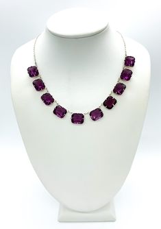 "Antique Art Deco Sterling Silver Amethyst Paste Rhinestone Riviere Necklace 15\" Up for offer is a beautiful antique art deco 1920s solid sterling silver and cushion cut amethyst paste rhinestone riviere necklace.  This necklace features a spring ring clasp.  Necklace is marked \"Sterling\". Time Period: 1920s Measurements Necklace Length: 15\" Chain Width: 1.5mm Amethyst Paste Rhinestones: 12mm x 9mm x 5.7mm Weight: 19.1 g Materials -Sterling Silver -Paste Rhinestone Condition: Excellent; item is pre-owned and may have some signs of light use.  Please inspect pictures for overall condition. This item comes from a clean, smoke free household.  Item will ship within 24-48 hours of sale.  Returns are accepted within 14 days.  There is a 7% restocking return fee for this item.  Please send a Purple Gemstone Necklace For Party, Purple Crystal Necklaces With Jewels, Purple Crystal Gemstone Necklace, Formal Amethyst Necklaces With Stones, Purple Crystal Jewelry With Stones, Riviere Necklace, 1920s Necklace, Necklace Art Deco, Art Deco 1920s