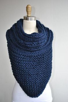 a blue knitted cowl on a mannequin with a white dummy behind it