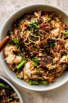 a white bowl filled with rice and vegetables