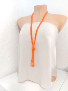 "Long orange necklace, v necklace, tassel necklace, knot necklace, boho multistrand necklace,  beaded bohemian necklace The knot is adjustable, simple to undo and redo at the height you would like! Or you can wear the necklace double up without any knot! It is a very versatile necklace that can be adapted to your taste.   ❤ PROCESSING AND SHIPPING Most orders are made and shipped out in one business day. Please check delivery timeframes for your location on the description below.  ❤ CUSTOM ORDERS If you like this item in a different color, send me a message indicating: color, size and quantity needed. I will send you a link for a \"custom order\" and you'll be able to place the order there.  If you like this item with some variations such as thickness or style, please also send me a messag Handmade Orange Multi-strand Necklace, Adjustable Orange Multi-strand Necklaces, Handmade Lariat Tassel Necklace, Orange Beaded Necklaces For Beach, Orange Multi-strand Beaded Necklaces For Beach, Handmade Tassel Necklace For Beach, Adjustable Long Orange Necklace, Bohemian Orange Necklace For Summer, V Necklace