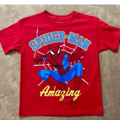 Get Your Little Superhero Ready To Save The World In This Marvel Spiderman Red Jersey Style Boy's Shirt. The Shirt Features A Bold Spiderman Graphic On The Front That Will Make Any Boy Feel Like A True Hero. Made For Boys Size Large 10/12, This Shirt Is Brand New And Ready To Wear. The Bright Red Color And Jersey Style Add An Extra Touch Of Cool To Any Outfit. Perfect For Everyday Wear Or A Special Occasion, This Shirt Is A Must-Have For Any Spiderman Fan. Fun Red Top With Cartoon Print, Fun Red Shirt With Cartoon Print, Spiderman Graphic, Red Jersey, Marvel Shirt, Jersey Style, Save The World, Boy Tees, Marvel Spiderman