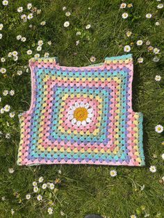 New to our crochet festival collection, the Daisy Rainbow Vest ☮️  Handmade crochet featuring a daisy flower & rainbow granny stitches 🌼 - Size MEDIUM (10/12) 🧶 Made with 100% Cotton yarn  🌻 This vest has slight stretch & fits a little baggy 💌 Free UK delivery 🌎 Ships with Royal Mail from Wiltshire, UK  📮 International shipping prices vary depending on location & are calculated at checkout  Measurements: Chest: 36 inches Length (shoulder to waist): 15 inches    This vest is ready to ship, please allow up to a week to receive your order depending on where you are.  Care & washing instructions: - Handwash OR wash on DELICATE cycle at low temperature - Wash inside a pillow case or an organza bag - Air dry flat - Do NOT tumble dry - Avoid ironing & hot temperatures Cotton Crochet Top With Granny Square For Festival, Spring Green Crochet Patterns, Handmade Multicolor Crochet Top For Spring, Spring Cotton Crochet Patterns, Spring Festival Crochet Top With Granny Square, Spring Multicolor Crochet Patterns, Summer Festival Crochet Patterns, Spring Multicolor Hand Knitted Crochet Top, Hand Knitted Multicolor Crochet Top For Spring