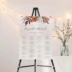 an easel with a wedding seating chart on it