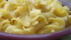 a purple bowl filled with macaroni and cheese