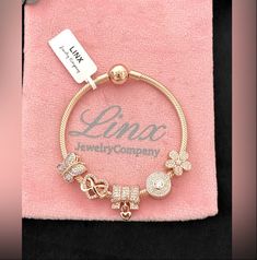 Linx Smooth snake chain style charm bracelet in 18k rose gold over 925 sterling silver, with a ball clasp.  *Bracelet is available in multiple sizes.  *Bracelet will come in a luxury velvet jewelry pouch, making it perfect for gift giving also.  *Bracelet includes 5 Linx charms in 18k rose gold over 925 sterling silver.  * Additional charms can also be added to this bracelet.  *Bracelet is compatible with all standard size open works charms, including  Linx, Pandora, and Gnoce, so you can add al Cheap Rose Gold Charm Bracelet Gift, Luxury Rose Gold Cubic Zirconia Bracelet, Affordable Personalized Rose Gold Charm Bracelet, Cheap Rose Gold Charm Bracelet For Gift, Cheap Rose Gold Charm Bracelet, Affordable Rose Gold Charm Bracelet, Adjustable Cheap Rose Gold Charm Bracelet, Luxury Rose Gold Charms Jewelry, Luxury Rose Gold Charm Bracelet As Gift