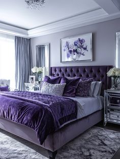 a bedroom with purple bedding and chandelier