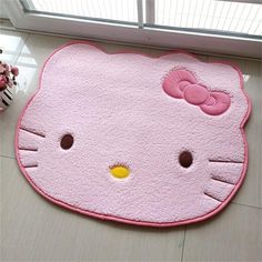 a pink hello kitty rug on the floor