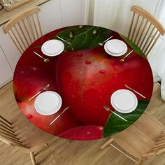 the table is set with plates and place settings for four people to eat in front of an apple