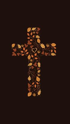 a cross with leaves and hearts on it in the middle of a black wallpaper