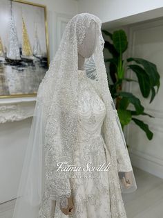 a wedding dress on display in front of a painting