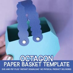 a person holding up a paper basket with the word octagon on it in front of them