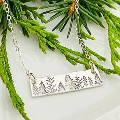 "Forest Necklace, Evergreen Tree Necklace, Nature Lover Gift, Bar Necklace, Forest Jewelry  1/4\" x 1\" sterling silver bar is stamped with a beautiful forest scene.  Each one is different! It hangs from a dainty sterling silver cable chain." Tree Bar, Forest Jewelry, Forest Necklace, Beautiful Forest, Tree Necklace, Evergreen Trees, Silver Bar, Silver Bars, Gifts For Nature Lovers