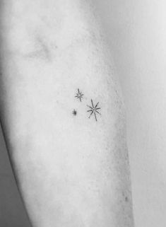 small stars tattoo on the left side of the right arm