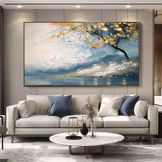 a living room filled with furniture and a large painting on the wall above it's coffee table