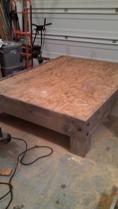 an unfinished bed frame in a garage