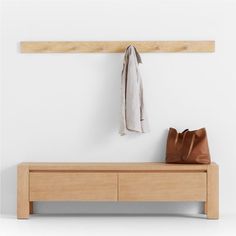 a wooden bench with a bag and coat rack