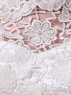 the back of a wedding dress with white lace