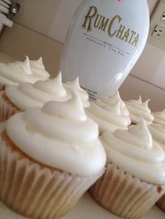 cupcakes with white frosting sitting on a counter