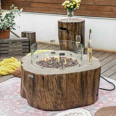 a fire pit sitting on top of a wooden table