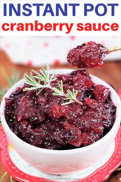 cranberry sauce in a white bowl with rosemary sprigs on the side