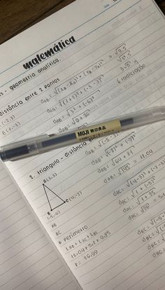 a pen sitting on top of a piece of paper next to a calculator