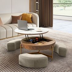 a living room filled with furniture and a laptop computer on top of a coffee table