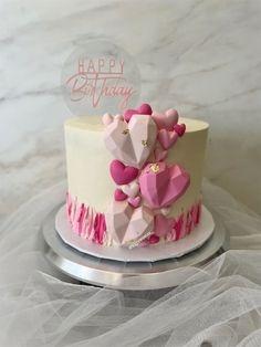 a birthday cake with pink and white decorations