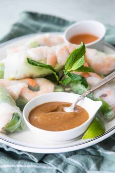 shrimp spring rolls with dipping sauce on a plate