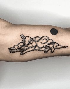 a man's arm with an ink drawing of three pigs on the left side of his arm